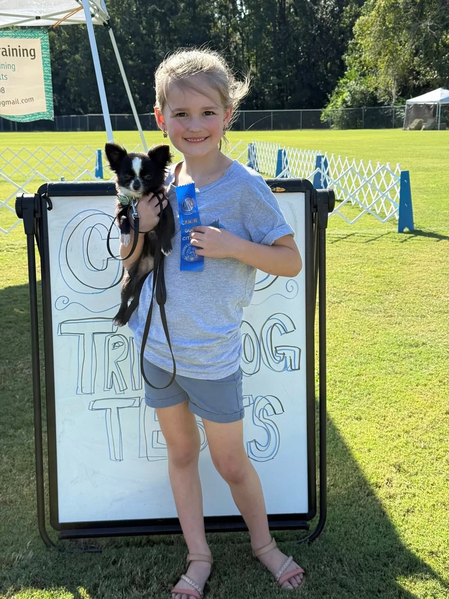 Kaitlin holding Feyre and her ribbon at the CGC and Trick Dog tests